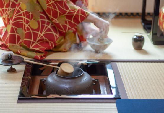 Japanese tea ceremony with kimono and steaming tea kettle